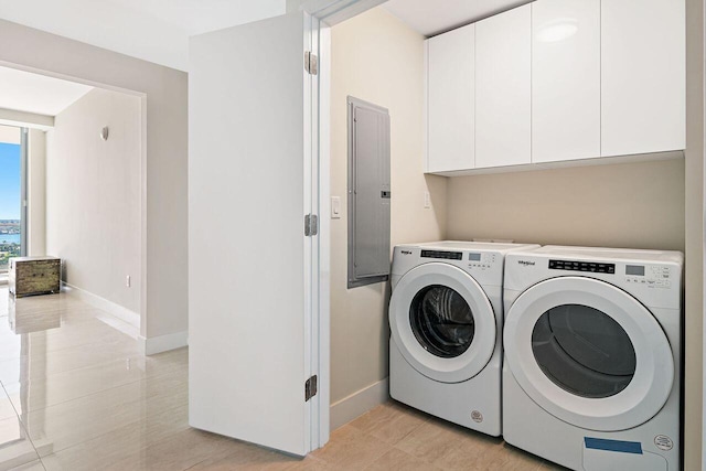 laundry room featuring cabinets, independent washer and dryer, and light tile floors