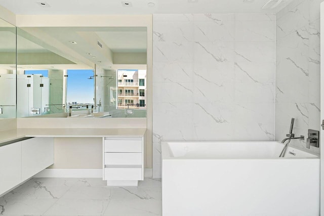 bathroom with vanity, tile floors, and a bath to relax in