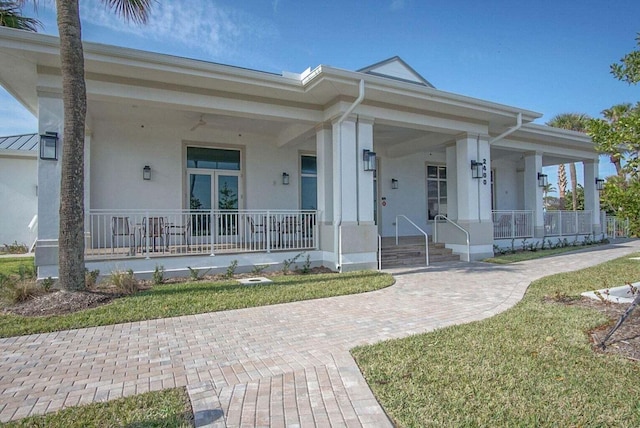 view of front of house with covered porch and stucco siding