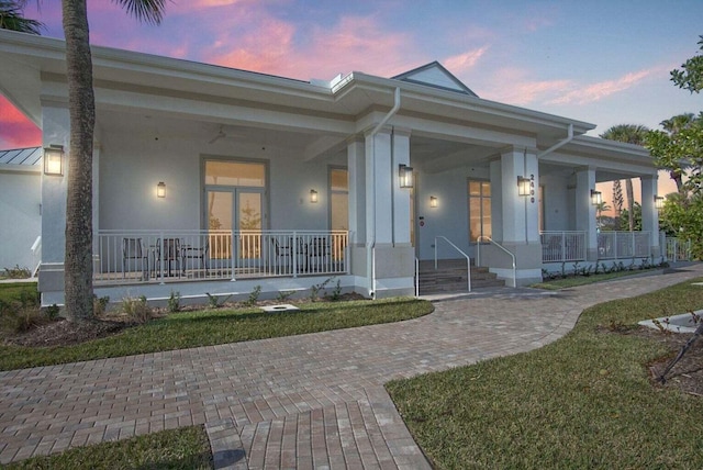 view of front of property featuring stucco siding and a porch