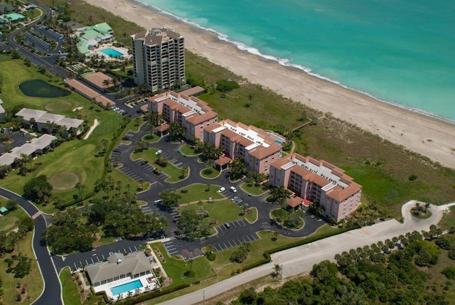 drone / aerial view featuring a beach view and a water view