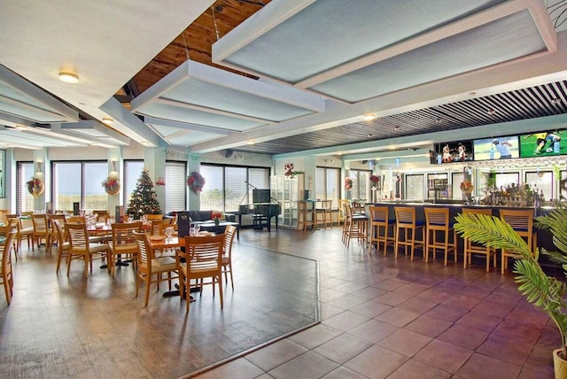 tiled dining room featuring a wealth of natural light and a community bar