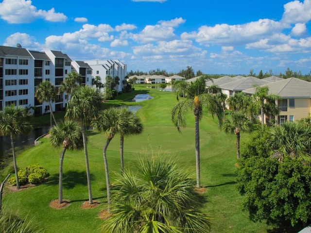 view of community featuring a lawn, a water view, and a residential view