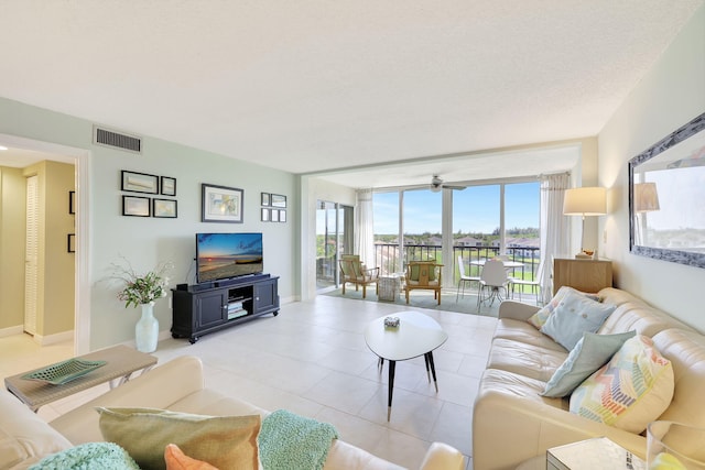 tiled living room with ceiling fan