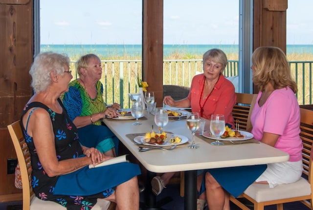 dining room with a view of the beach and a water view