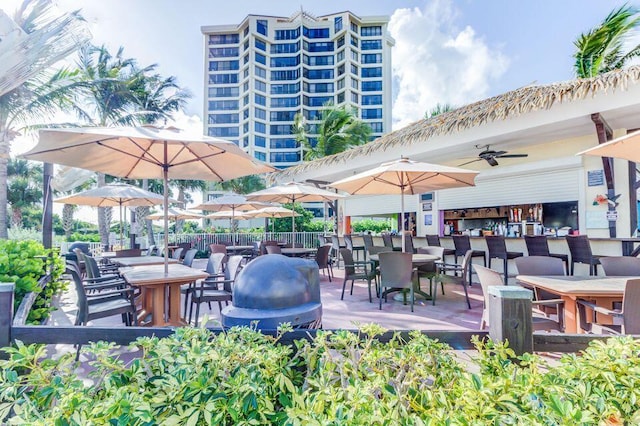 view of patio / terrace with an outdoor bar and ceiling fan