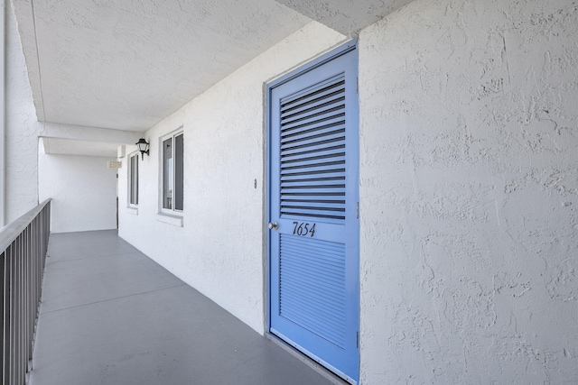 view of exterior entry with stucco siding