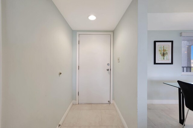 corridor featuring light tile patterned flooring