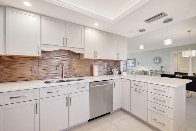 kitchen featuring dishwasher, pendant lighting, kitchen peninsula, and sink