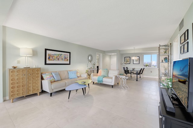 tiled living room featuring a textured ceiling