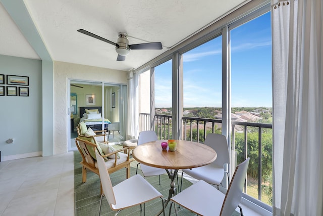 sunroom / solarium featuring ceiling fan