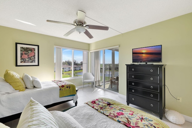 bedroom featuring baseboards, ceiling fan, light tile patterned flooring, a textured ceiling, and access to outside