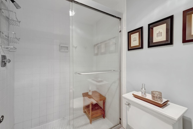 full bath with toilet and a stall shower