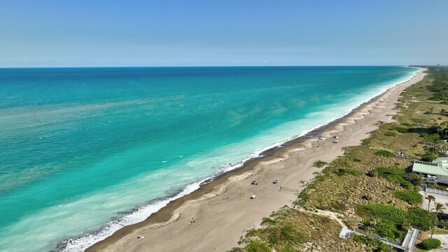 aerial view featuring a water view and a view of the beach