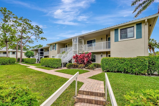 23 Westgate Ln Unit E, Boynton Beach, FL 33436 - view of property featuring stairway