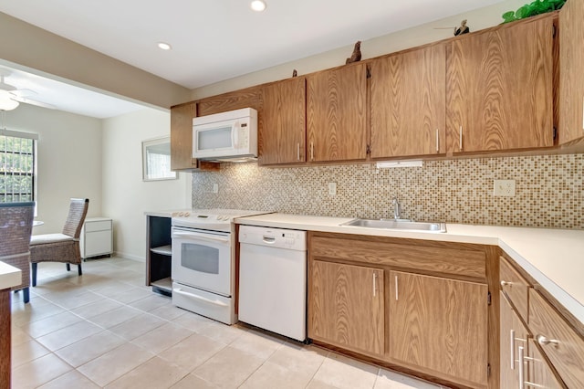 kitchen with white appliances, light tile patterned floors, tasteful backsplash, sink, and ceiling fan