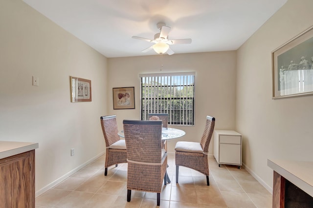 dining space featuring light tile patterned flooring and ceiling fan