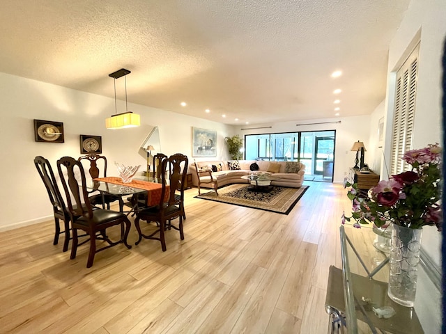 23 Westgate Ln Unit E, Boynton Beach, FL 33436 - dining room with recessed lighting, light wood finished floors, a textured ceiling, and baseboards