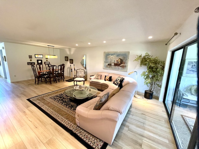 23 Westgate Ln Unit E, Boynton Beach, FL 33436 - living room featuring light wood-type flooring, recessed lighting, baseboards, and a textured ceiling