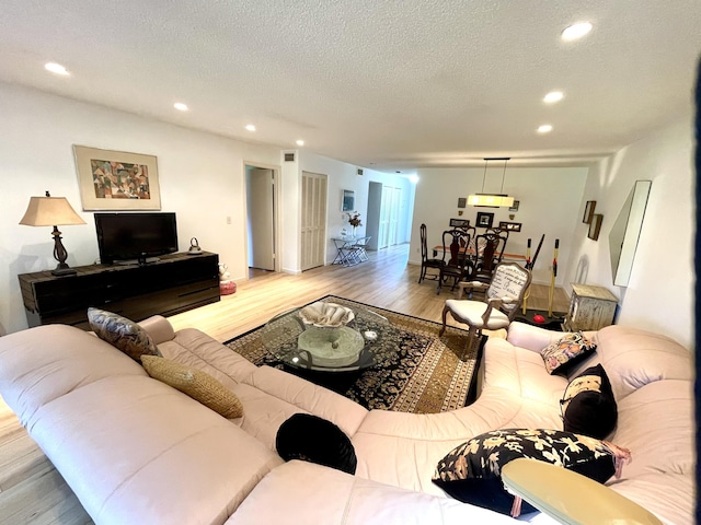 23 Westgate Ln Unit E, Boynton Beach, FL 33436 - living room featuring recessed lighting, wood finished floors, and a textured ceiling