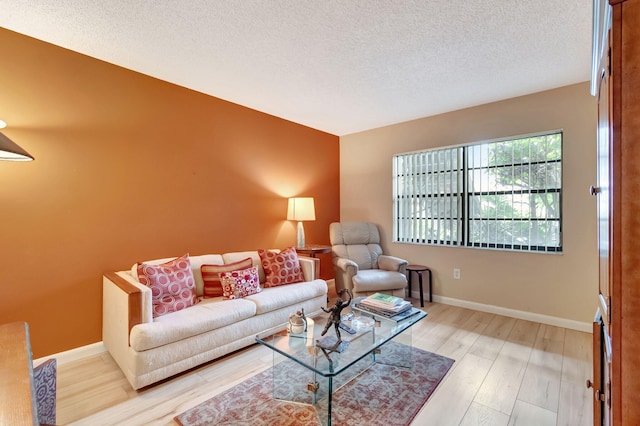 living room with hardwood / wood-style floors and a textured ceiling