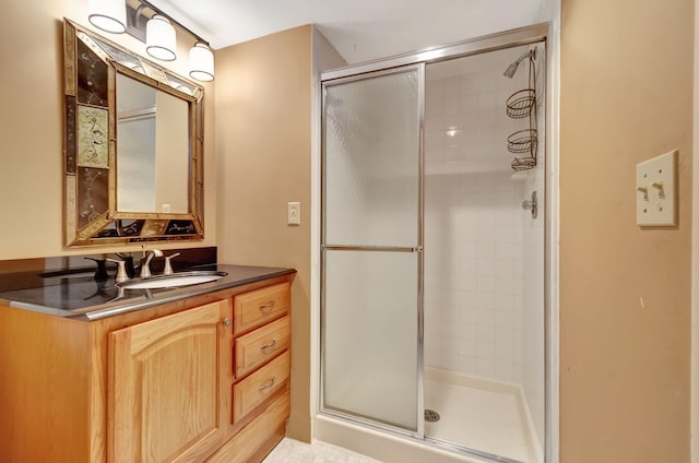 bathroom with vanity and a shower with door