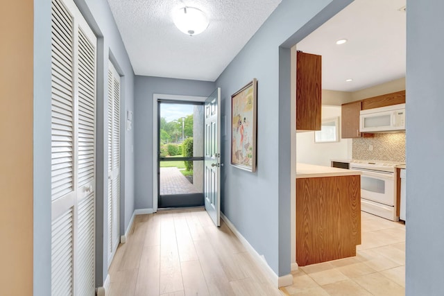 23 Westgate Ln Unit E, Boynton Beach, FL 33436 - entryway featuring baseboards and a textured ceiling