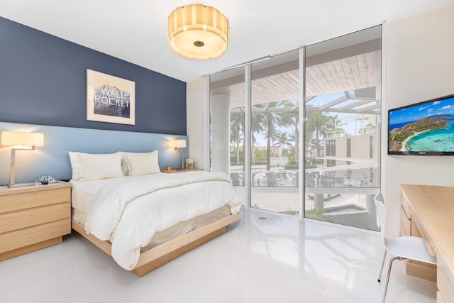 bedroom with floor to ceiling windows, access to exterior, and light tile flooring