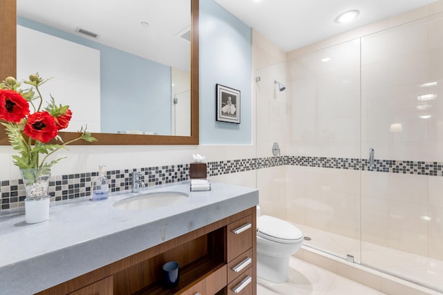 bathroom featuring walk in shower, backsplash, oversized vanity, tile flooring, and toilet