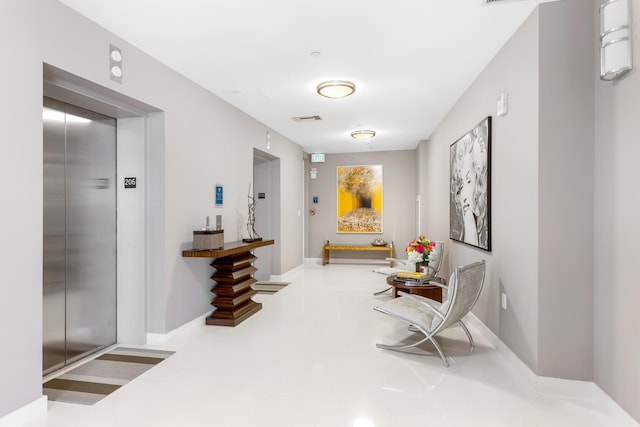 sitting room with elevator and tile floors