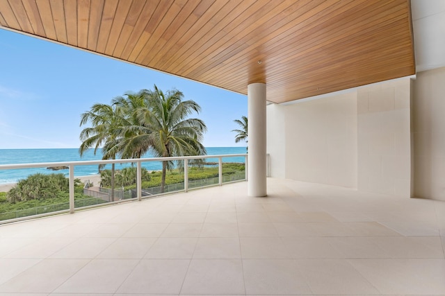 view of patio / terrace featuring a water view and a balcony