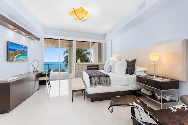 tiled bedroom with a water view and access to exterior