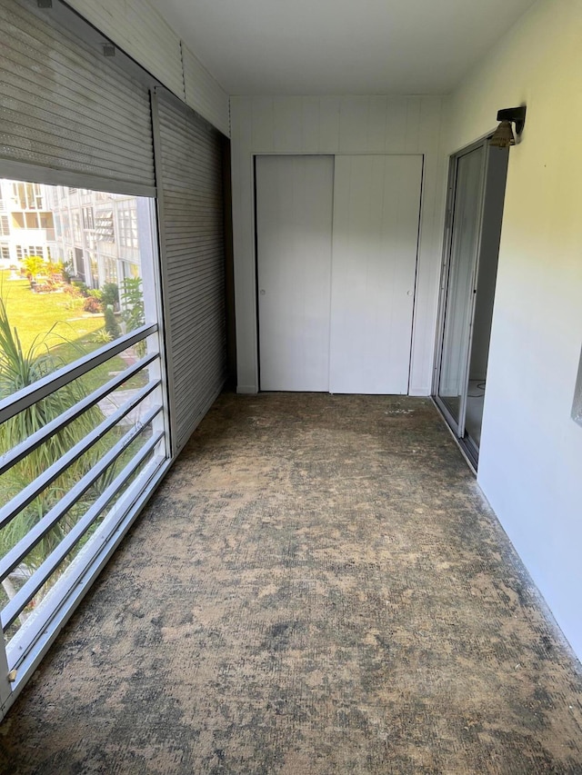 corridor featuring dark colored carpet