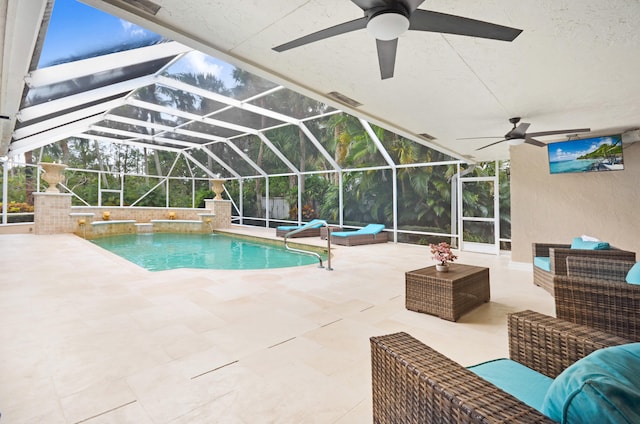 view of swimming pool with glass enclosure, a patio area, pool water feature, ceiling fan, and an outdoor hangout area