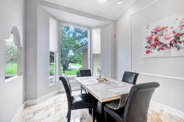 tiled dining area featuring crown molding