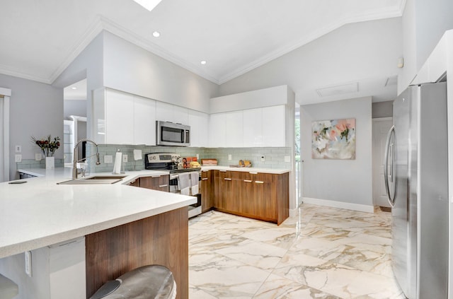 kitchen with lofted ceiling, tasteful backsplash, stainless steel appliances, and white cabinetry