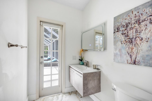 bathroom with toilet, tile floors, and vanity