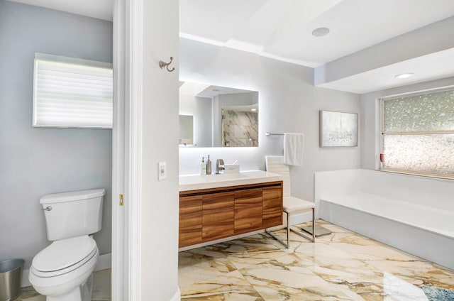 bathroom featuring tile flooring, a healthy amount of sunlight, toilet, and large vanity