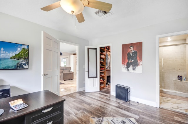 interior space featuring hardwood / wood-style floors and ceiling fan