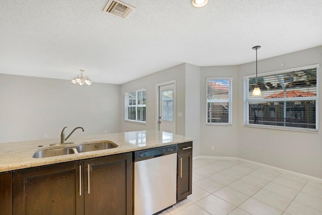 kitchen featuring light stone counters, sink, decorative light fixtures, an inviting chandelier, and dishwasher