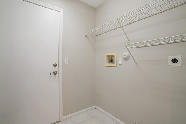 laundry room with gas dryer hookup, hookup for a washing machine, light tile patterned floors, and hookup for an electric dryer