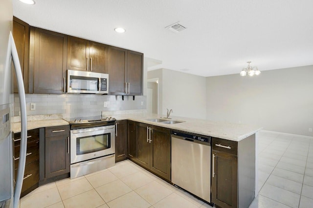 kitchen with kitchen peninsula, light tile patterned flooring, and appliances with stainless steel finishes