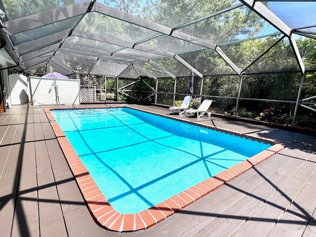 view of swimming pool featuring a lanai