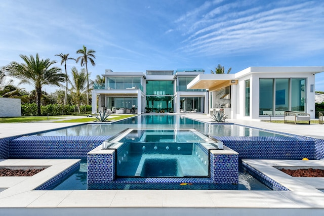 view of swimming pool with an in ground hot tub