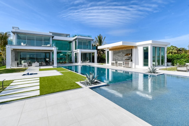 view of pool featuring a lawn and a patio