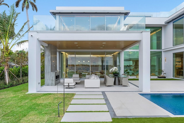 back of house with a patio area and a lawn