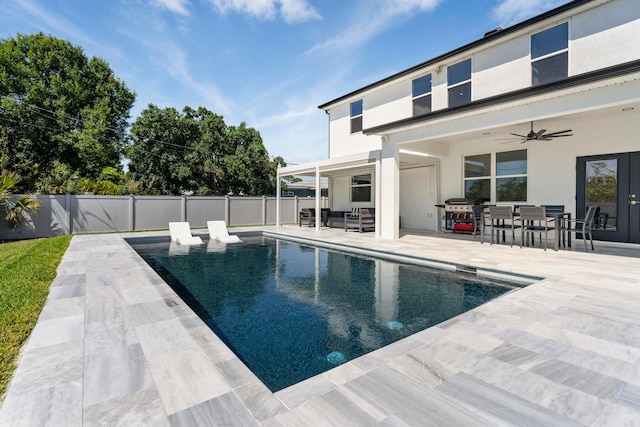 view of pool with ceiling fan, area for grilling, and a patio