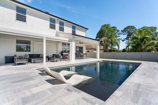 view of swimming pool with ceiling fan, a grill, outdoor lounge area, and a patio area