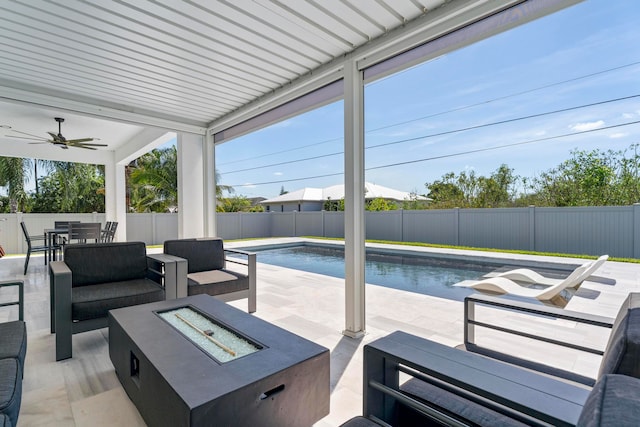 view of patio / terrace with a fenced in pool, an outdoor living space with a fire pit, and ceiling fan