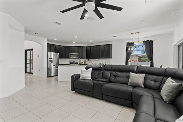 tiled living room with ceiling fan